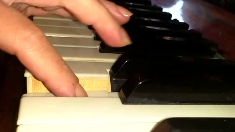 The hands play the piano Stock Footage