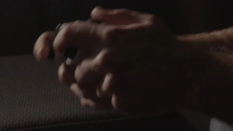 Hands playing aggressively on a videogame controller in a dark living room Stock Footage 221756830