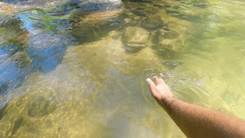 Hands playing and touching the water. Having fun on vacation weekend trip Stock Footage 170512027