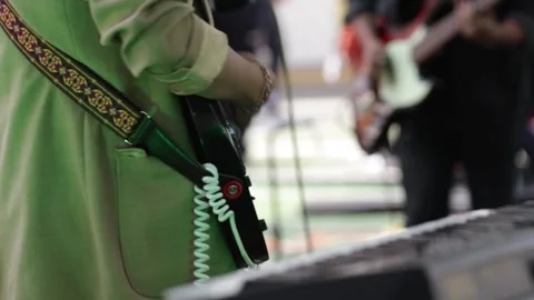 Hands playing a black electric guitar at a live concert. Stock Footage 221661988