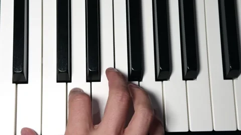 Hands playing C and G chords on piano keys Stock Footage 312903050