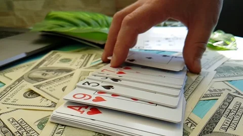 Hands playing cards dollars slow motion Stock Footage 88141299