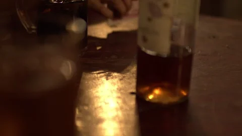 Hands Playing with Cards with drinks on a Table, Beer, Cups Wine Video stock 255744780