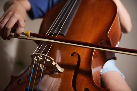 Hands Playing a Cello Using a Bow, Highlighting Music Performance Stock Photos