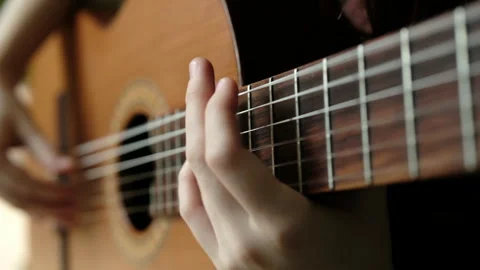 Hands playing chords on guitar inspired string Video stock 278428485