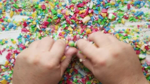 Hands playing with colorful cut soap pieces in ASMR video Stock Footage 310143718