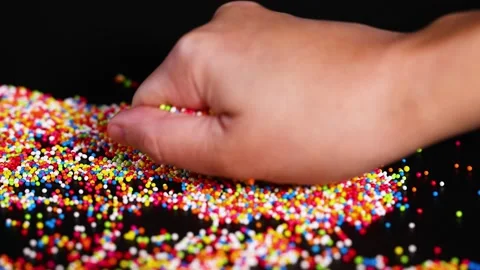 Hands Playing with Colorful Sprinkles Stock Footage 312306799