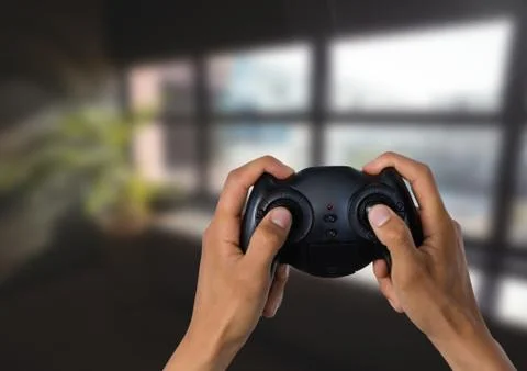 Hands playing with computer game controller with bright blurred background Stock Photos