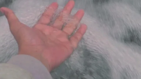 Hands playing flowing waterfall Stock Footage 288856029