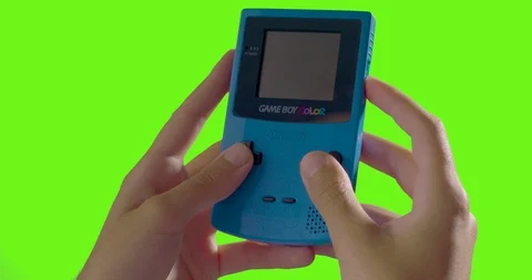 Hands Playing Gameboy on green screen Stock Footage
