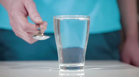 Hands playing glass cup with spoon music kitchen Stock Footage 62399990