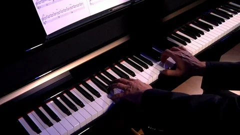 Hands playing the keyboard of a piano. Stock Footage 129875540