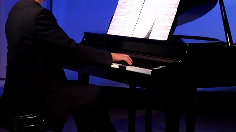 Hands playing the keyboard of a piano. Stock Footage 129876615