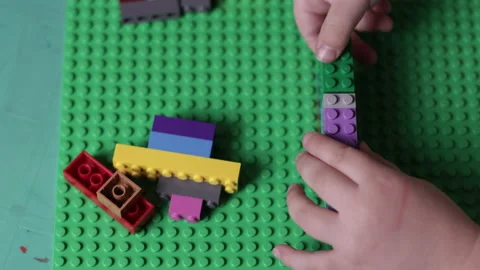 Hands playing with Lego bricks, education and creative concept Stock Footage 167342177