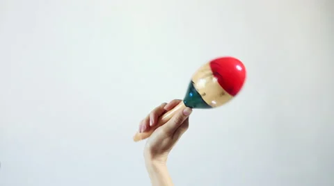 Hands playing marakas (Shakers), white background Stock Footage 59643640