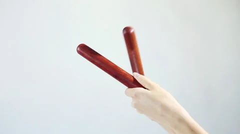 Hands playing on the musical sticks (percussion). Knock several times on a wh Stock Footage 59642979