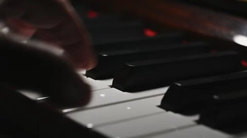 Hands Playing Piano Keys in Close Up with Dramatic Lighting Stock Footage 345089890
