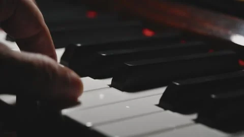 Hands Playing Piano Keys in Close Up with Dramatic Lighting Stock Footage 345089903