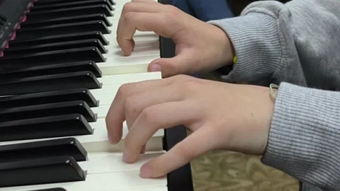 Hands playing piano keys during music lesson or rehearsal, Stock Footage 337542712
