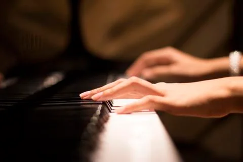 Hands playing piano Stock Photos