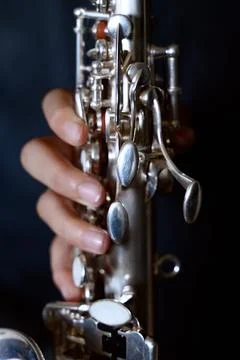 Hands playing a silver saxophone Stock Photos