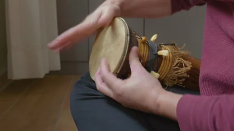 Hands Playing a Small Percussion Instrument Decorated with African Motifs Stock Footage 327278712