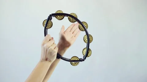 Hands playing on tambourine (shaker), shake several times Stock Footage 59642208