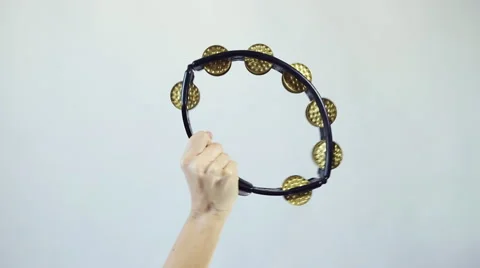 Hands playing on tambourine (shaker), shake several times 스톡 동영상 59643655