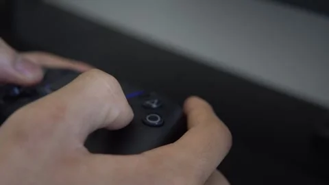 Hands playing a video game using a wireless console controller Stock Footage 341707142