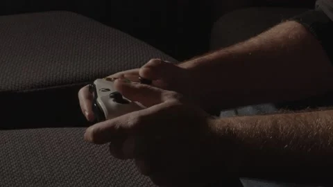 Hands playing with a videogame controller in a dark room Stock Footage 221756779