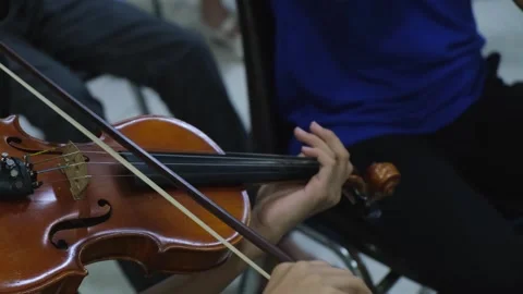 Hands playing the violin, bowing up and down and the left-hand fingers Stock Footage 255876753