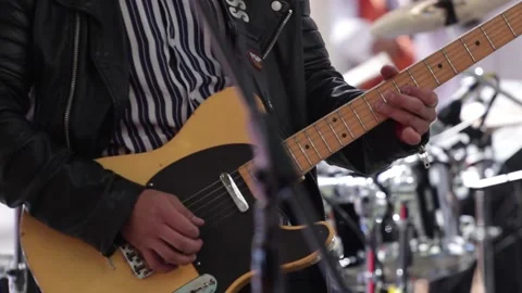 Hands playing a yellow electric guitar Stock Footage 221662055