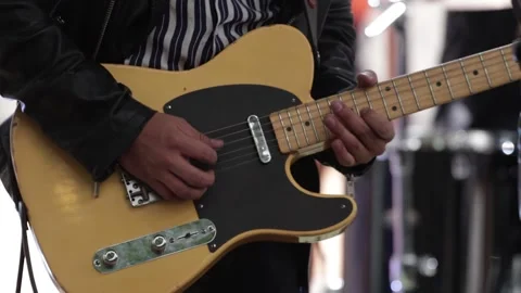 Hands playing a yellow electric guitar at a live concert. Stock Footage 221662068