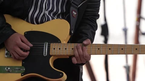 Hands playing a yellow electric guitar at a live concert. Stock Footage 221662266