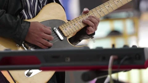 Hands playing a yellow electric guitar Stock Footage 221662295