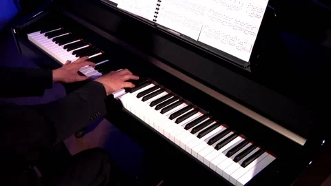 Hands playng the keyboard of a piano Stock Footage 130564156