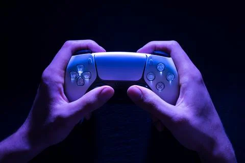 Hands with PlayStation Controller View of a dark background. Udine, Italy F.. Stock Photos