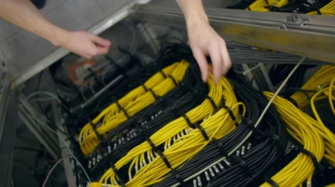Hands plug out the yellow ethernet cable Stock Footage
