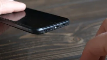 Hands plugging the charger into cell phone Stock Footage 85952149