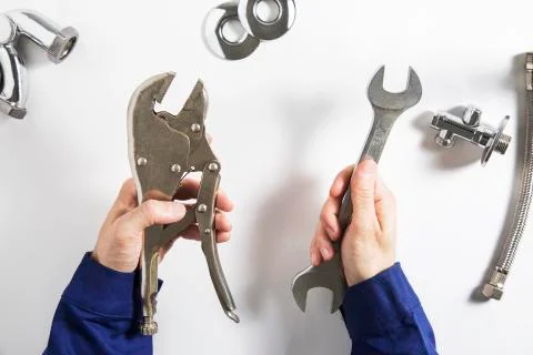 Hands of plumber at work Stock Photos