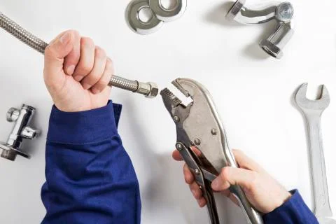 Hands of plumber at work Stock Photos