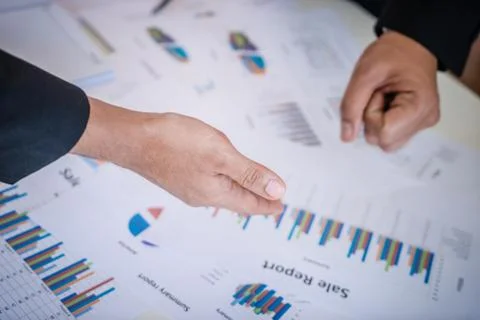 Hands pointing on data chart sheet for business meeting Stock Photos