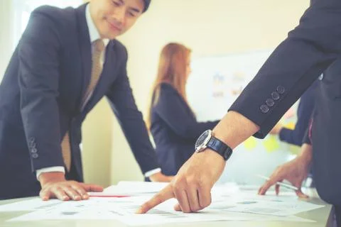 Hands pointing on data chart sheet for business meeting Stock Photos