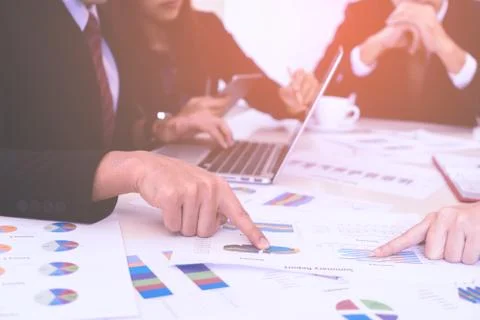 Hands pointing on data chart sheet for business meeting Stock Photos