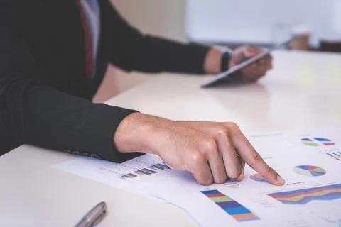 Hands pointing on data chart sheet for business meeting Stock Photos