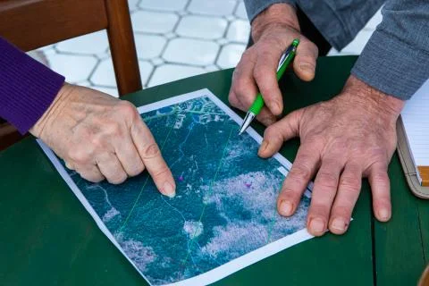 Hands pointing on localization on a map Stock Photos