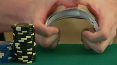 Hands on a poker table shuffling a deck of cards and dealing Stock-Footage 920016