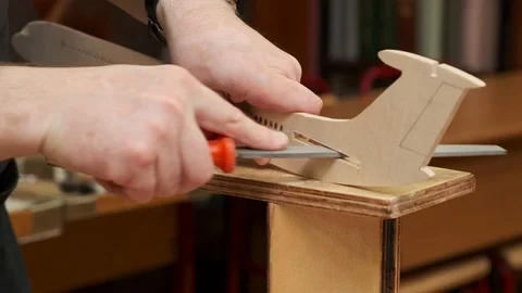 Hands polish outdated passenger jetliner model fuselage Stock Footage 127377729