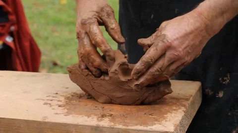 Hands of a Potter closeup. A lump of clay in men's hands. Stock Footage 82178635