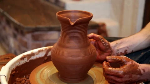 Hands of a potter, creating an earthen jar on the circle Stock Footage 50990532